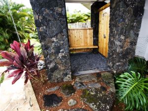 Outdoor lava rock shower with cedar walls and bench Outdoor lava rock shower with cedar walls and bench